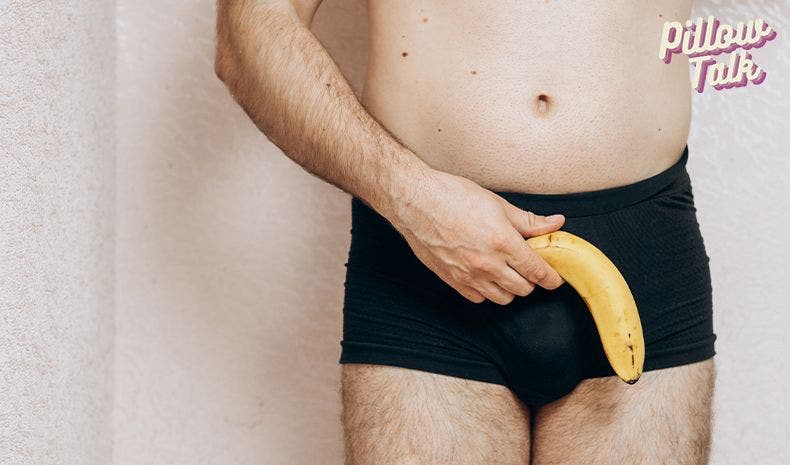 Torso and lower half of a man without a shirt, in black briefs holds a sad looking banana
