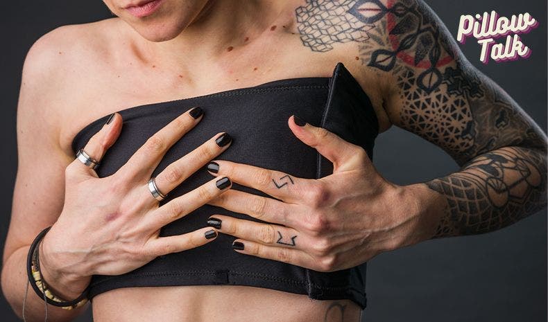Person with tattoos putting on a chest binder