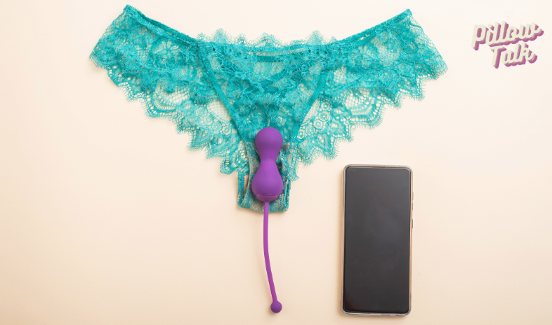 a pair of panties on a table with an remote control egg vibe on top of the panties and a cell phone next to them