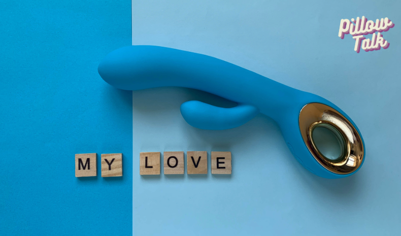 a dark blue rabbit vibrator on a light blue background with the scrabble tiles under it that spell out "my love"