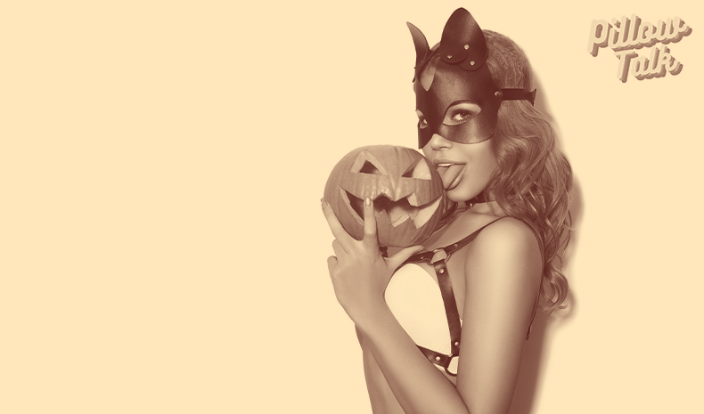 Woman with fetish mask licks a pumpkin provocatively